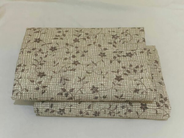 Bed linen with a small floral pattern on a checkered background.