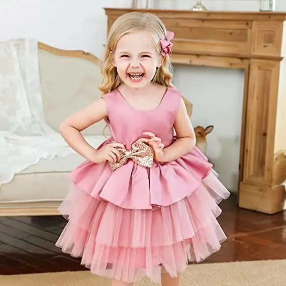 Pink bouffant dress with golden bow for a girl 