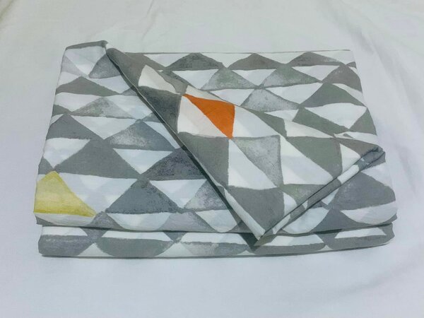 A set of bed linen with a geometric pattern in gray, orange and yellow tones