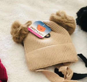 Hat with pompon for a girl beige