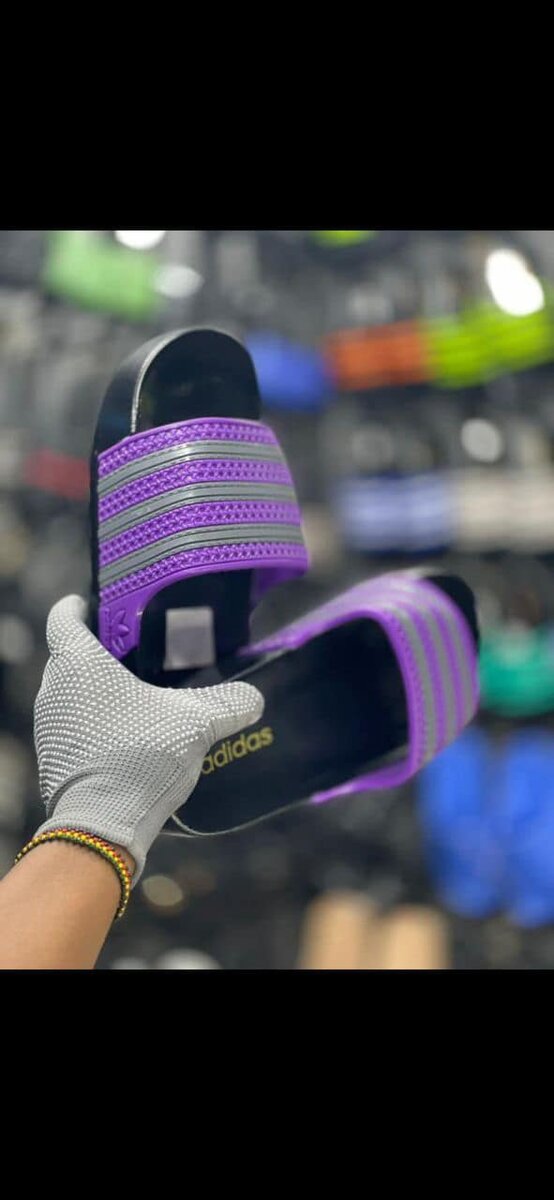 Men's black Adidas flip-flops with purple inserts and gray stripes, made of synthetic material