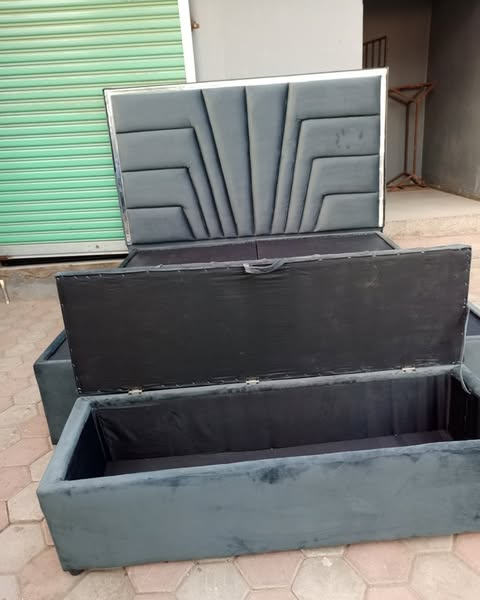 grey bed with carved headboard