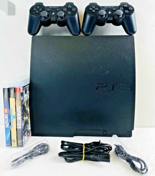 Console PS3 avec 2 manettes et jeux vidéo