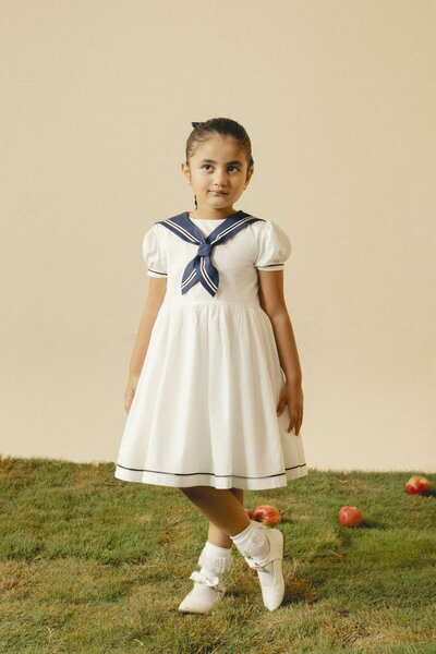 Camellia | White cotton dress with sailor collar and pleated skirt