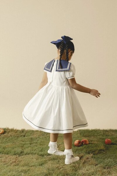 Camellia | White cotton dress with sailor collar and pleated skirt