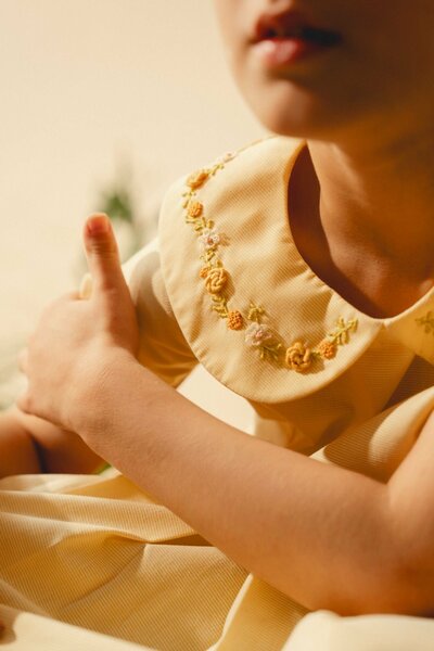 Marigold | Cream cotton blend pleated dress with hand-embroidered collar
