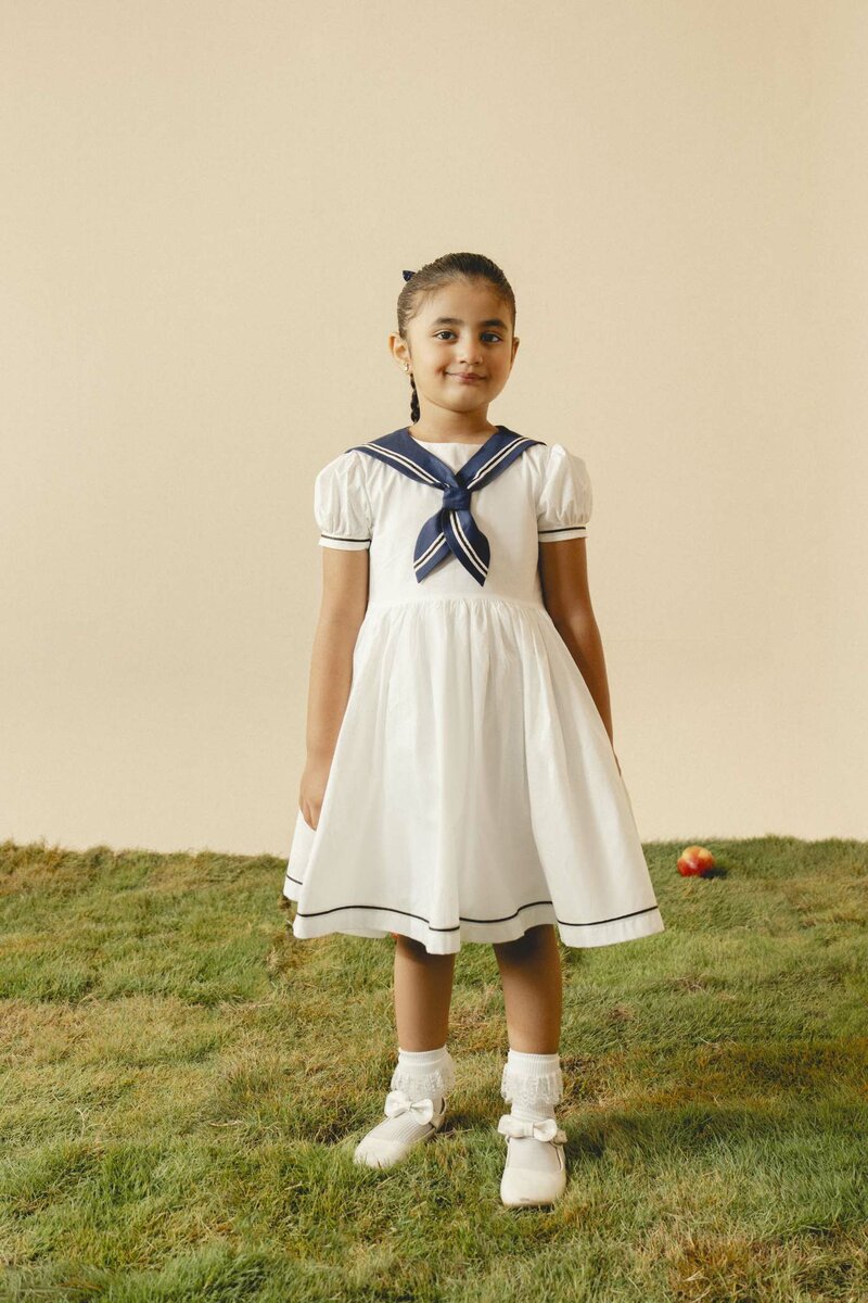 Camellia | White cotton dress with sailor collar and pleated skirt