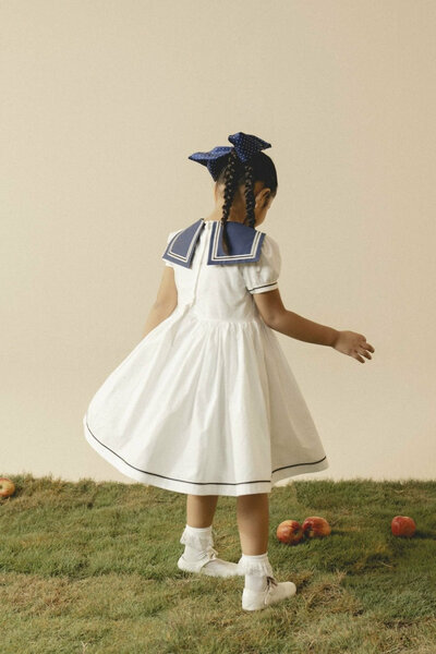 Camellia | White cotton dress with sailor collar and pleated skirt