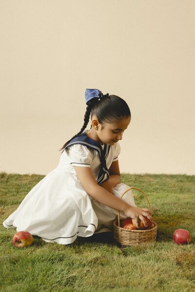 Camellia | White cotton dress with sailor collar and pleated skirt