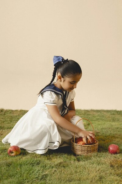 Camellia | White cotton dress with sailor collar and pleated skirt