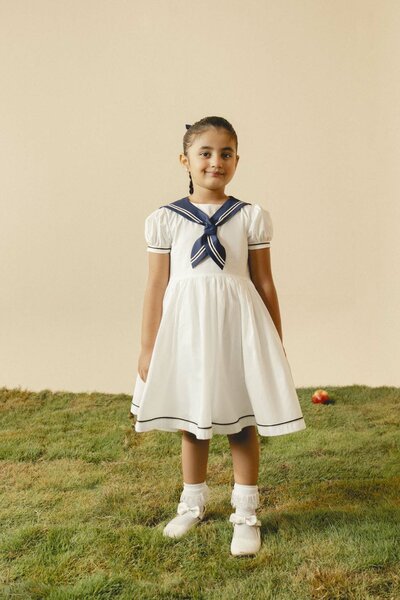 Camellia | White cotton dress with sailor collar and pleated skirt