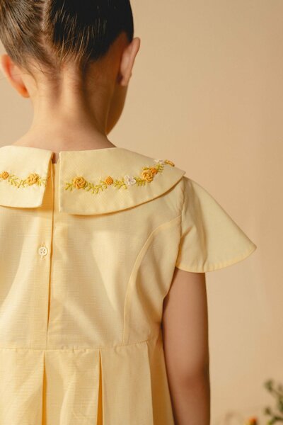 Marigold | Cream cotton blend pleated dress with hand-embroidered collar