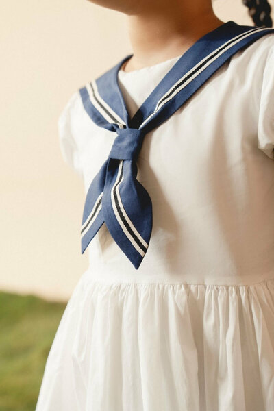 Camellia | White cotton dress with sailor collar and pleated skirt