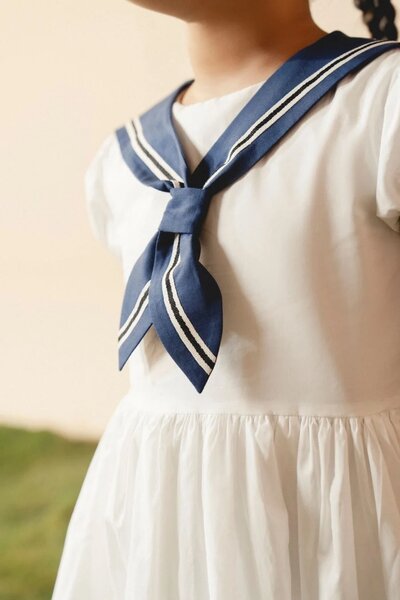 Camellia | White cotton dress with sailor collar and pleated skirt